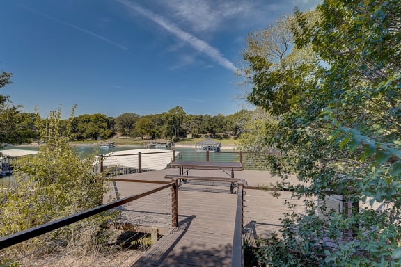 a deck with a ping pong table overlooking a body of water at The Legends at Eagle Mountain Lake, Fort Worth, 76179